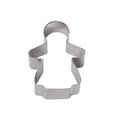 A metal cookie cutter in the shape of a smiling gingerbread girl.